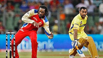 Royal Challengers Bangalore’s Chris Gayle, left, makes an attempt to run out Chennai Super Kings’ captain MS Dhoni, right, during last night’s thrilling game.
