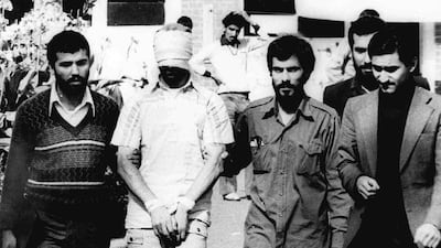 This photo from November 9, 1979, shows one of the 52 American hostages who were held for more than 444 days at the US embassy in Tehran, Iran, being paraded blindfolded before a crowd. AP Photo