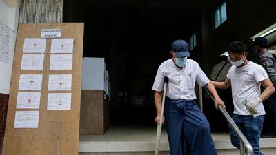 An elderly man leaves after casting his ballot in Yangon. EPA