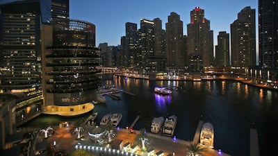 A traditional dhow cruise crosses the Dubai Marina waterfront canal during a night tour. Kamran Jebreili / AP Photo