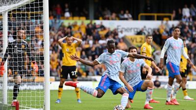 United's Aaron Wan-Bissaka clears the ball after a misssed chance by Romain Saiss of Wolves. Getty