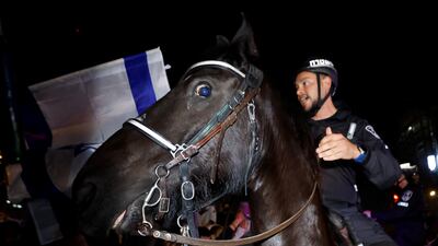 A mounted police officer gestures during a demonstration in Tel Aviv. Reuters