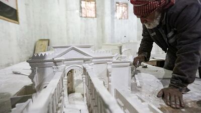 An assistant works on Ali Saleh's model of the ancient city of Palmyra, which was first mentioned in records more than 2,000 years ago, in al-Bab, northern Syria. AFP