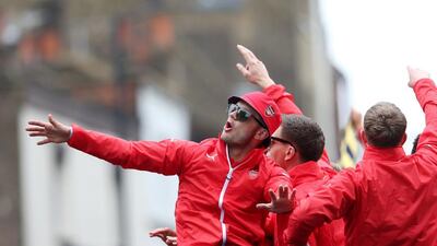 Arsenal's Jack Wilshere, left, celebrates with team mates during their bus top English FA Cup victory parade through the streets of London, Sunday May 31. AP Photo
