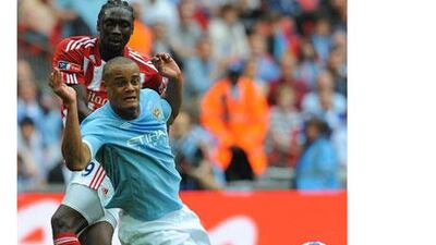 Manchester City manager Roberto Mancini has rewarded Vincent Kompany, foreground, with the team's captaincy.