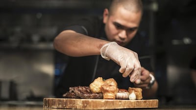 Chef John Buenaventura sets his steak plate at Seafire steakhouse in Atlantis, The Palm, Dubai. Reem Mohammed / The National