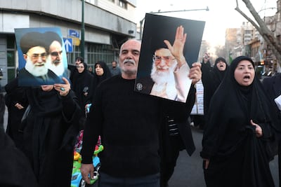 Mourners hold up pictures of Iran's assassinated supreme leader Ayatollah Ali Khamenei. AFP