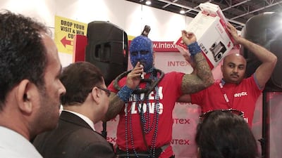 Loy Machedo, in the blue mask, is the auctioneer for Intex Technologies and leads the bidding for electronic gadgets at Gitex Shoppers 2013. Intex and the other companies displaying at Gitex are preparing for even busier times over the Eid Al Adha break. Jeffrey E Biteng / The National