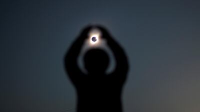 A person gestures while observing a solar eclipse at Incahuasi, Chile. Reuters