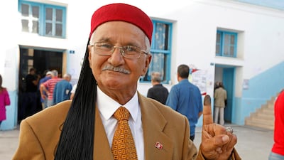 A man shows his ink-stained finger after casting his vote at a polling station during parliamentary elections, in Tunis, Tunisia. Reuters