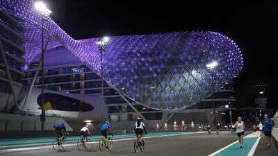 Bike riders, walkers and runners take to the track at Yas Marina last night in preparation for Tri Yas, which has been billed as the first triathlon to be held at a Formula One circuit.