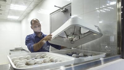 Paul Hamilton, head curator at the Dubai Aquarium and Underwater Zoo, checks on the eggs. Reem Mohammed / The National