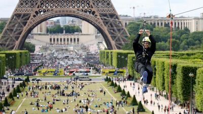 A participant rides a zip line from the second floor of the Eiffel Tower, 115 metres above the ground along an 800-metre long route, as part of a free event operating until June 11 in Paris. Charles Platiau / Reuters