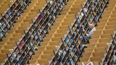 Workers put together orders at the Amazon logistics centre in Brieselang, Germany November 11, 2014. Hannibal / Reuters