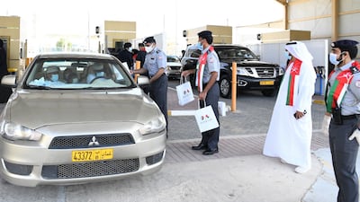 Abu Dhabi Police on Wednesday greeted travellers from Oman with roses and gifts as land ports reopened. Photos: Abu Dhabi Police