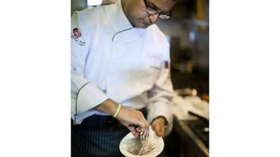 The Indian chef Atul Kochhar cooks a sea bream dish in Ushna's kitchen, in Abu Dhabi's Souk Qaryat al Beri.