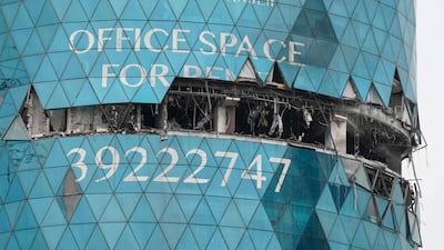 A building bears the scars of an Iranian drone attack, in the Seef district of Manama, Bahrain. AFP