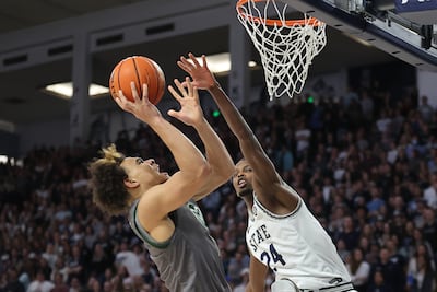 Colorado State Rams guard John Tonje (1) shoots against Utah State Aggies forward Zee Hamoda (24). Reuters