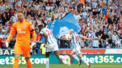 Huddersfield Town’s Aaron Mooy celebrates scoring their first goal as Newcastle United’s Robert Elliot looks dejected. Carl Recine / Reuters