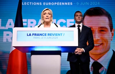 National Rally leader Marine Le Pen speaks in Paris as party president Jordan Bardella looks on after Mr Macron's announcement. AFP