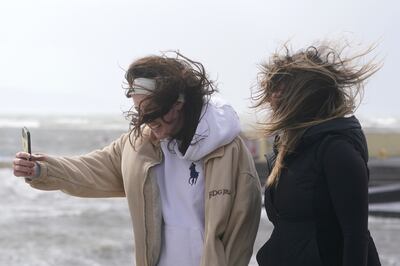 People take selfies on the promenade in Salthill, Galway, Ireland. Storm Kathleen continued its journey across Scotland on Sunday. PA