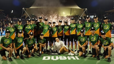 Jessica Pegula with with the ball boys and girls after her win in Dubai. Reuters