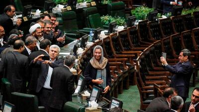 Former Iranian foreign ministry spokesman Hassan Ghashghavi, right, uses a cell phone to take a picture of EU foreign policy chief Federica Mogherini standing together with Iranian MPs after the conclusion of the swearing in ceremony of the Iranian president before parliament in Tehran. AFP