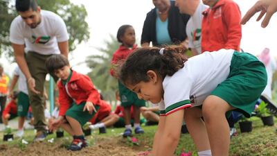 Children from Giggles nursery school in Abu Dhabi help to plant more than 1,000 flowers at Khalidiya Park in the city on March 16, 2014, the opening day of UAE Green Festival 2014. The month-long festival is aimed at promoting a more eco-conscious lifestyle. Ravindranath K / The National