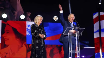 King Charles and the queen consort, wearing a wool and cashmere blend robe by Saudi designer Yahya Al Bishri, on stage during the platinum jubilee concert on June 4, 2022. AP