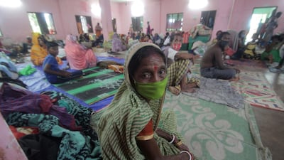 People sit in a temporary cyclone relief shelter at Paradeep, Odisha, India. EPA