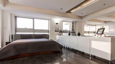 The mezzanine level has the main bedroom, a walk-in closet and a bathroom. Courtesy Luxhabitat
