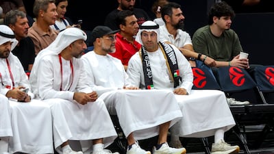 Khaldoon Al Mubarak, CEO of Mubadala Investment Company, right, watches the game from courtside.