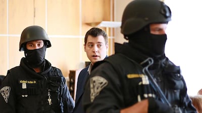 Kevin Dahlgren, centre, a US citizen, at the courthouse in Brno. He was found guilty of murdering a Czech family of four he was staying with in 2013. Radek Mica / AFP Photo