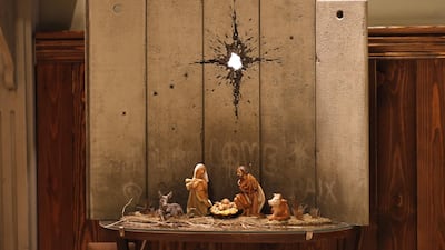 A new Christmas-themed artwork dubbed the "Scar of Bethlehem" by secretive British artist Banksy is displayed at his Walled-Off Hotel in Bethlehem in the occupied West Bank on December 20, 2019. / AFP / AHMAD GHARABLI