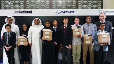 From left, Nikhil Potula, Rashid Murooshid, Acting Editor-in-Chief of The National, Alia Al Mansoori, Khaled Al Hashmi, a director at the UAE Space Agency, Haneefah Badar, Akio Shirali, Matteo Sottocornola, Wilson Huijsmans, Karun Isaac, Zack Rahman and Kevin Foley, Boeing global sales and marketing manager, the finalists and sponsors in Genes in Space on Sunday night. Delores Johnson / The National