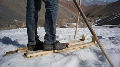 A local boy shows off his wooden skis and poles. Rick Findler for The National