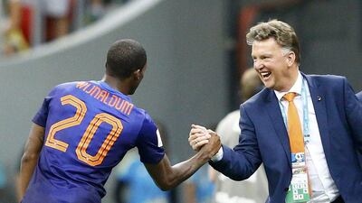 Georginio Wijnaldum of the Netherlands, left, celebrates with coach Louis van Gaal after scoring his team's third goal against Brazil during their 2014 World Cup third-place playoff at the Brasilia national stadium in Brasilia July 12, 2014. Van Gaal starts his new job at Manchester United on Wednesday. REUTERS/Dominic Ebenbichler