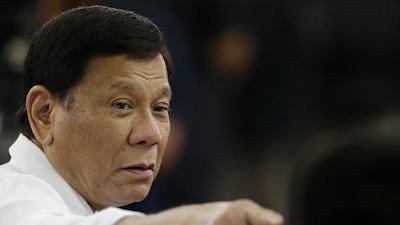 Philippine president Rodrigo Duterte gestures as he arrives to visit the Bureau of Jail Management and Penology on the outskirts of Manila on October 18, 2017. Aaron Favila / AP