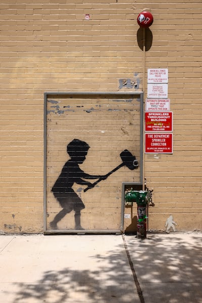 The Hammer Boy stencil was part of Banksy's month-long show on the streets of New York. AFP