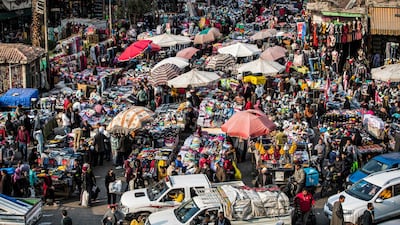 Street vendors sell merchandise at their stalls in the central Attaba district of Egypt's capital Cairo. AFP