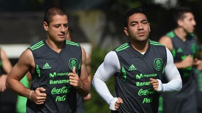Mexico forward Javier Hernandez, left, and midfielder Marco Fabian run during a training session at the O'Rei Pele Training Center in Santos during the 2014 Fifa World Cup on June 26, 2014. Yuri Cortez / AFP
