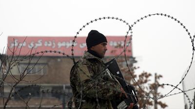 An Afghan national army soldier stands guard at the site of a suicide attack near a military academy in Kabul, Afghanistan. AP Photo