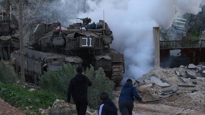 Palestinians throw stones as Israeli tanks enter Jenin refugee camp in the West Bank. EPA