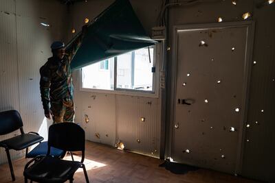 Maj Akakpo shows some of the damage done to the base hospital after it was his by a rocket during the war. Neither side claimed responsibility for the attack. Matt Kynaston for The National.