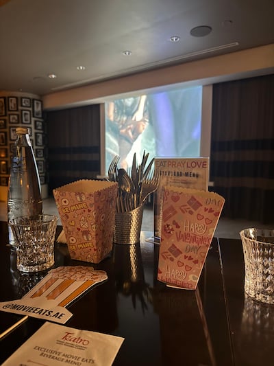 Cutlery, water, napkins, a drinks menu and popcorn are placed at each seat before the experience begins. Nour Ibrahim / The National