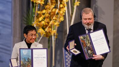 Ressa and Mr Muratov of Russia pose with the Nobel Peace Prize award and medal in Oslo, in December 2021. AFP