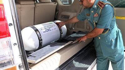 Essa Ali Al Hosani, director of technical and workshops, branch checks a gas-fuelled patrol cars elonging to Ajman Police. Satish Kumar / The National