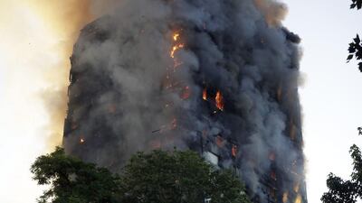 Smoke and flames rise from the building on fire in London. The fire is thought to have started at 1am London time. Matt Dunham / AP Photo