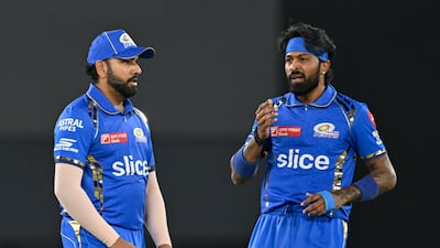 Mumbai Indians' captain Hardik Pandya and his teammate Rohit Sharma (L) gesture during the Indian Premier League (IPL) Twenty20 cricket match between Gujarat Titans and Mumbai Indians at the Narendra Modi Stadium in Ahmedabad on March 24, 2024. (Photo by Punit PARANJPE / AFP) / -- IMAGE RESTRICTED TO EDITORIAL USE - STRICTLY NO COMMERCIAL USE --