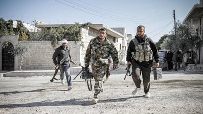 Rebels defending the town run towards a forward fighting position as the battle for Maaret Al Numan, in the southern Idlib province, continued between rebel forces and the Syrian government troops, on November 19, 2012. John Cantlie/AFP Photo